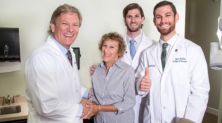 Drs. Rubino shaking hands with a patient
